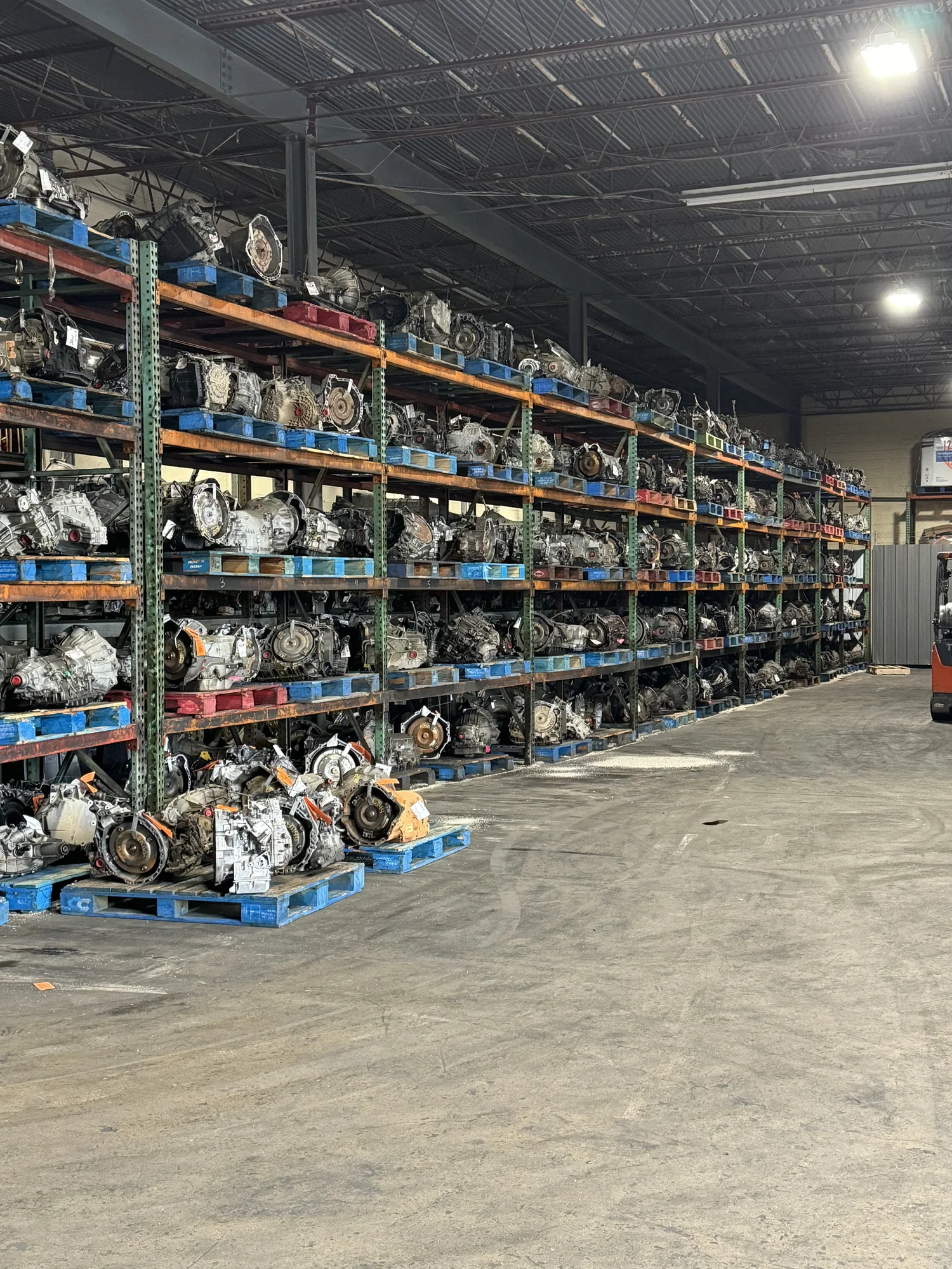 Rows of used transmissions organized inside the S&W Full Service warehouse